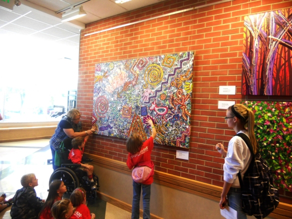 Visitors of all ages enjoy touching Robert's art. Children especially want to place their hands on the hand prints in the design of "The Story." 